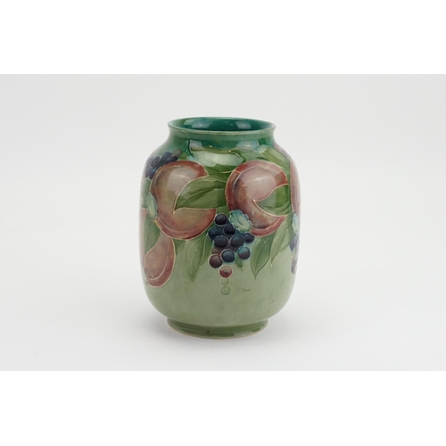 432 - A William Moorcroft pottery pomegranate vase, for Liberty & Co circa 1905. Decorated in blue, green ... 