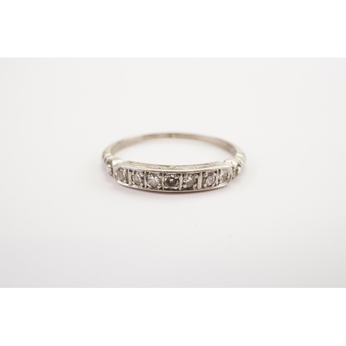 164 - A Diamond set Seven stone Band. Marked PLAT. Weight 2.6g. Size O.