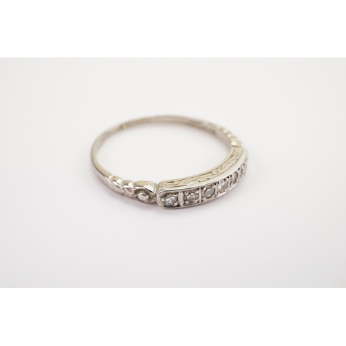 164 - A Diamond set Seven stone Band. Marked PLAT. Weight 2.6g. Size O.