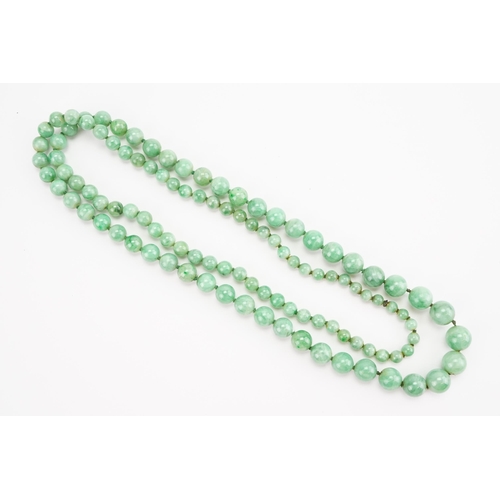 168 - A string of Graduated Jade bead necklace. Weight 59.1g. Length 74cm approx.