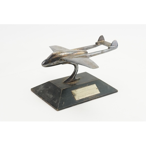 616 - A silver plated WWII Dh-115 Vampire model plane, resting on wooden base, presented to squadron leade... 