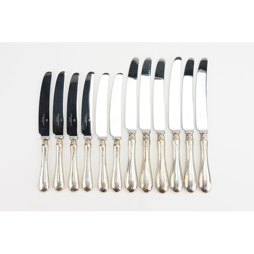 83 - A Set of 12 Silver handled Stainless Steel Knives.