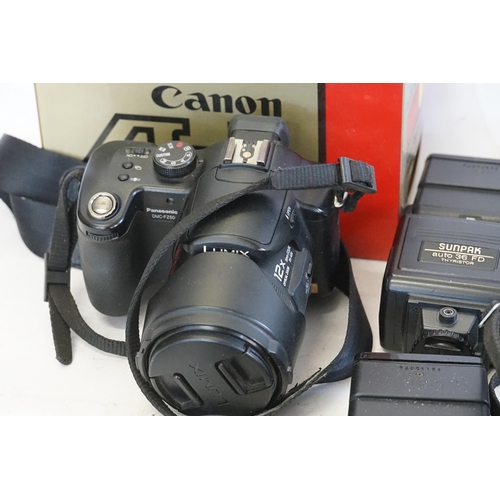 751 - Two Canon Cameras in Original Cases to include 2 x AE1 FD50mm 1.18SC, a Panasonic Mega D1S DMC FZ250... 