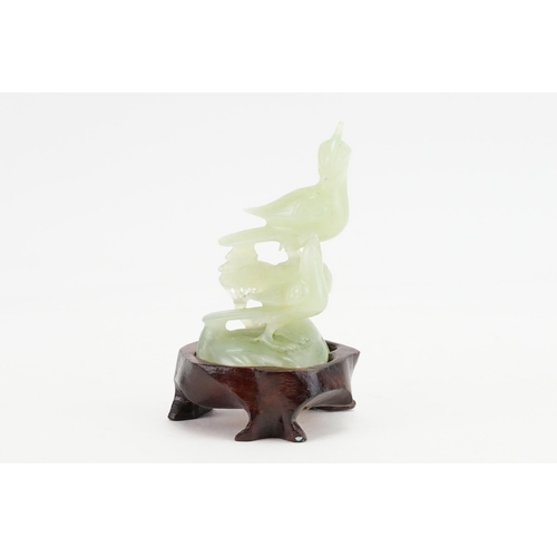 291 - A Chinese Jade carving of a Crow & Hawk on a rustic base. Measuring: 8cms high.