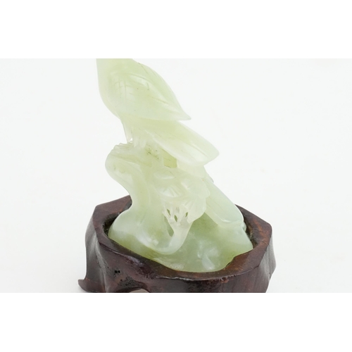 291 - A Chinese Jade carving of a Crow & Hawk on a rustic base. Measuring: 8cms high.