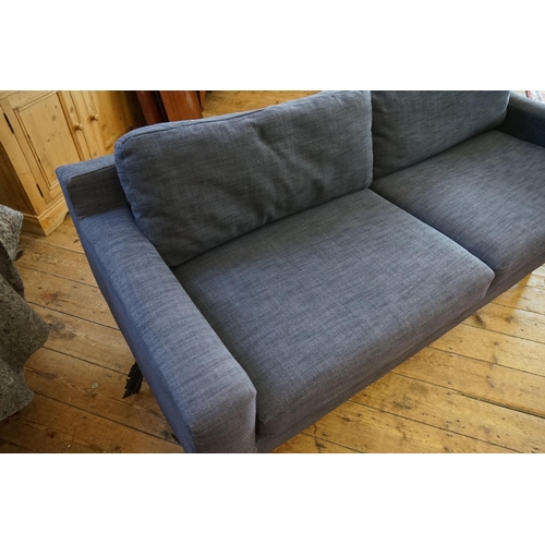 549 - A Low-Down Blue Twilled Covered Four Seater Settee with loose squab cushions. Measuring: 210cms acro... 