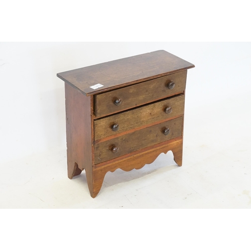 403 - A Miniature Apprentice Chest of Three Long Drawers with turned handles & resting on bracket feet. Me... 