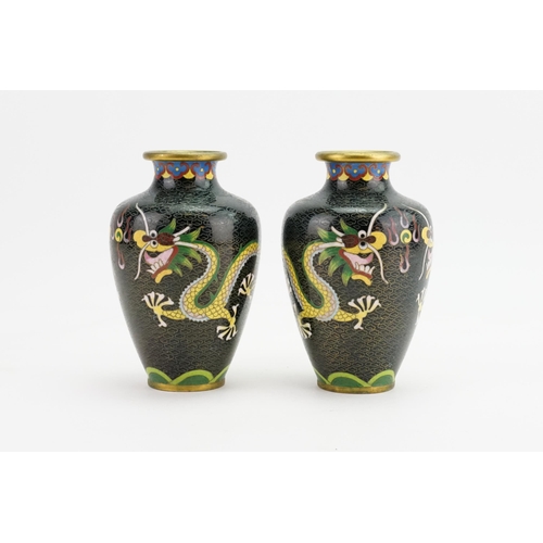 293 - A Pair of Black ground Chinese Cloisonne Vases decorated with Dragons. Measuring: 14cms high.