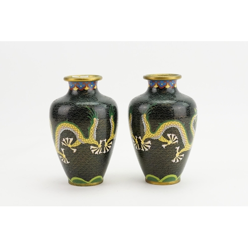 293 - A Pair of Black ground Chinese Cloisonne Vases decorated with Dragons. Measuring: 14cms high.