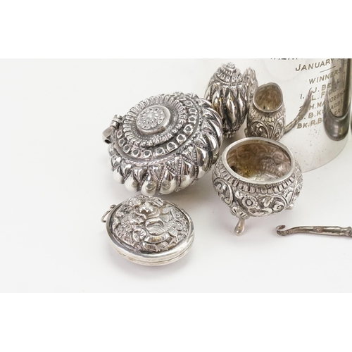 98 - A Silver coloured white metal Indian designed locket, along with similar pot and cruet, two tankards... 