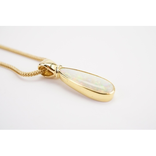 174 - A large Tear Drop Opal in an 18ct Gold setting (2.2g), hung on a 14ct Gold chain (4g).