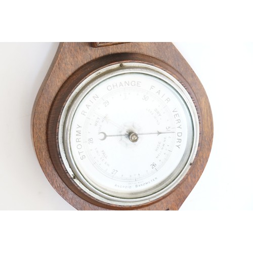 743 - An Edwardian Oak Banjo Barometer with Nickel Silver Dial. Measuring: 59cms High.