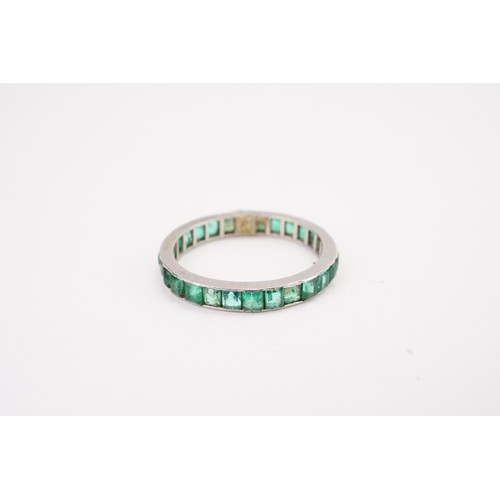 181 - A green paste mounted base metal full eternity ring.