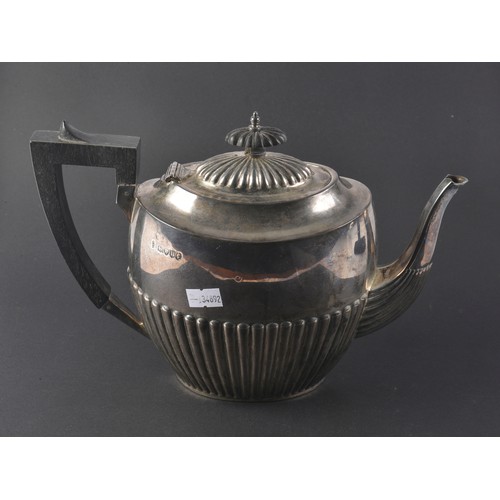 30 - A Victorian Silver Half Wing Fluted Tea Pot with an Ebony Handle, Maker: J E B, London H. Weighing 6... 