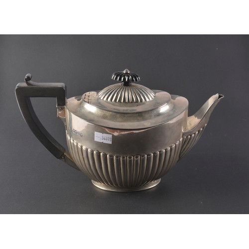 31 - A Victorian Silver Semi-Winged Fluted Tea Pot. Maker: B W J, London O. Weighing: 527 grams.