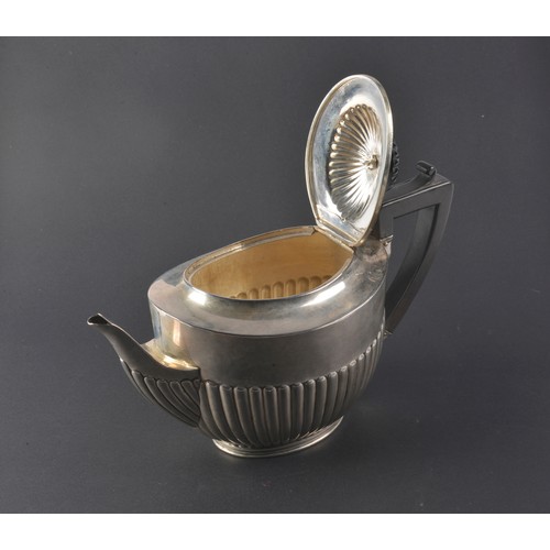 31 - A Victorian Silver Semi-Winged Fluted Tea Pot. Maker: B W J, London O. Weighing: 527 grams.