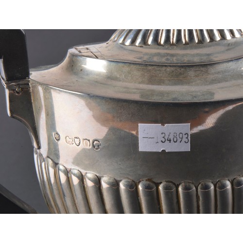 31 - A Victorian Silver Semi-Winged Fluted Tea Pot. Maker: B W J, London O. Weighing: 527 grams.