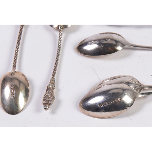 58 - Seven Various Silver Teaspoons & a Pair of Silver Sugar Tongs. Weighing: 90 grams.