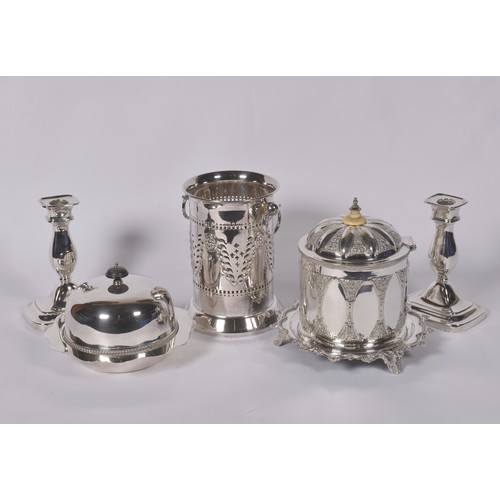 77 - A Victorian Silver Plated & Embossed Biscuit Barrel, Syphon Stand, Two Candlesticks & a Muffin Dish.