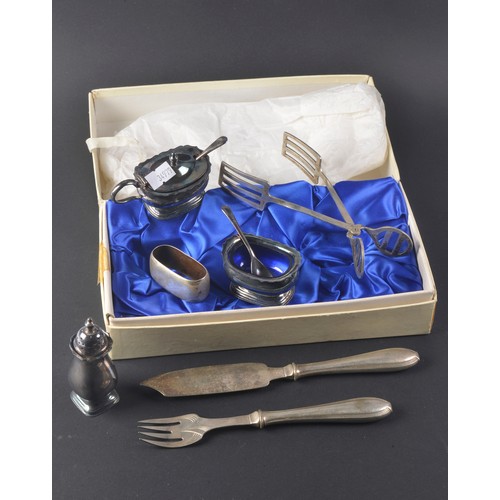 84 - A Pair of Silver Plated Cake Tongs, an (835) Napkin Ring & a Three Piece Silver Plated Cruet Set.