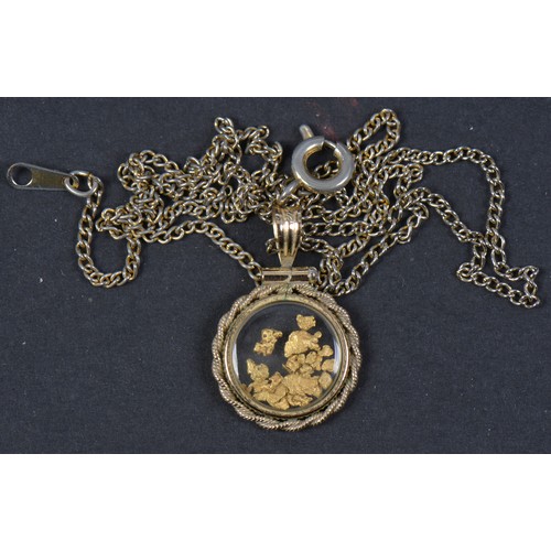 103 - A Locket of Rope Work pattern holding Fools Gold on Chain.