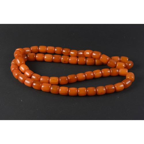 113 - A Large Turned 'Amber' Necklace on string.