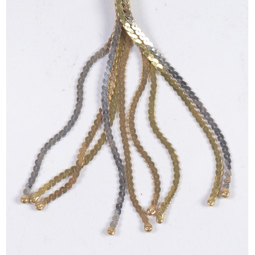 122 - A Twisted 18ct Gold Milanese Tassel Necklace in Two Tone Gold. Weighing: 11.5 grams.