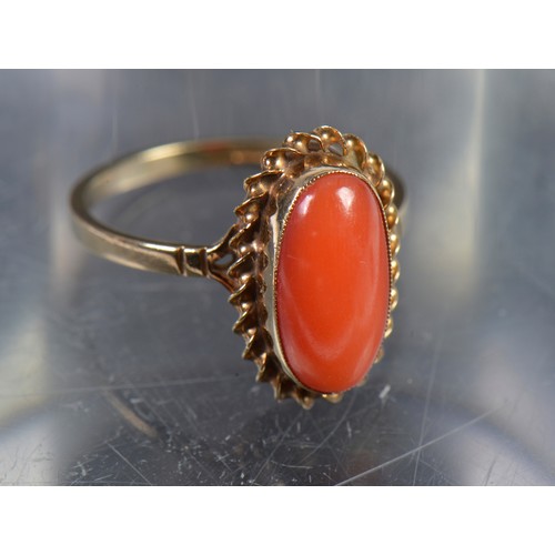 142 - A 9ct Gold mounted Coral Ring in a Rope Work Setting. Weighing: 2.4 grams. Size: M/N.