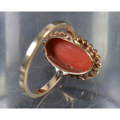 142 - A 9ct Gold mounted Coral Ring in a Rope Work Setting. Weighing: 2.4 grams. Size: M/N.