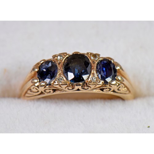 143 - A Ladies 9ct Gold Sapphire & Diamond Chip Dress Ring mounted with three Sapphires in a Claw Setting.... 