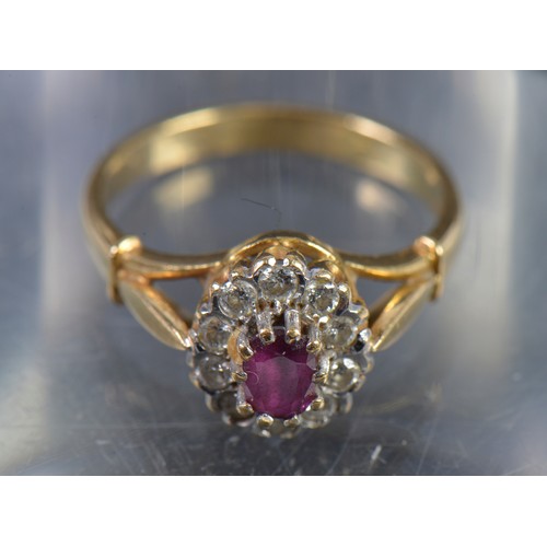 146 - A Ladies 18ct Gold Ring set with a Single Ruby & a Cluster of Diamonds. Weighing: 4.5 Grams. Size: N... 