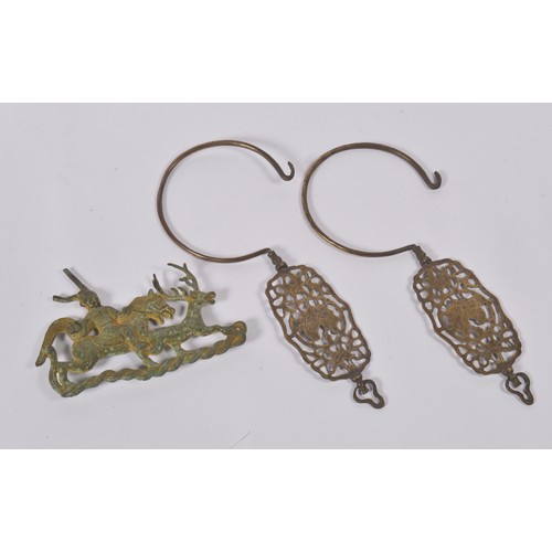 294 - A Pair of Brass Chinese Straits Curtain Hooks & a Bronzed Deer Hunter applique.