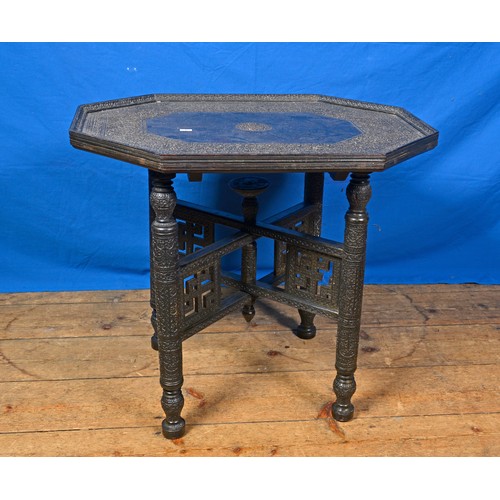 324 - A Cashmere carved Tiffin Table resting on folding stand. Measuring: 60cms x 45cms.