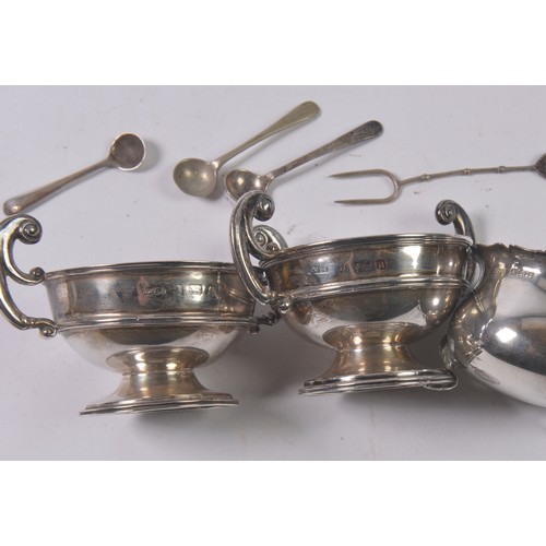 22 - A Pair of Trophy Cup Salt Cellars, a Mustard Pot & Spoons. Weighing: 161 grams.