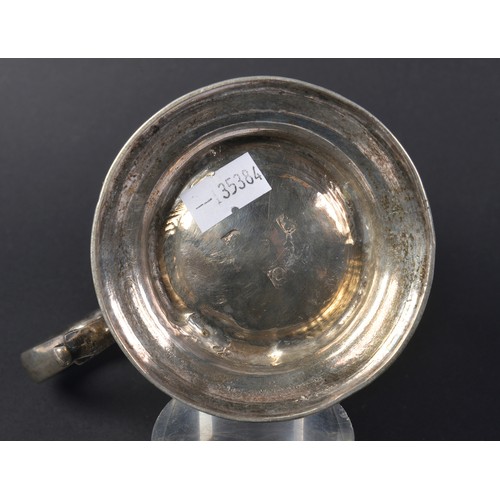 26 - A Georgian Silver Rococo Floral embossed Mug with a Flying Scroll Handle. Weighing: 321 grams.