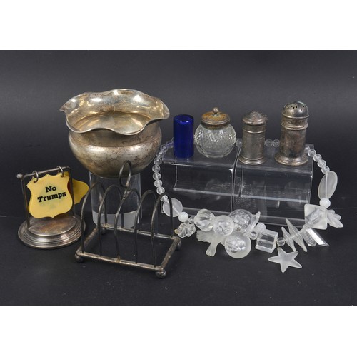 82 - A Silver Sugar Basin, a Silver Toast Rack, Pepper Pot & Bridge marker. Weighing: 159 grams. Along wi... 