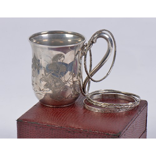 83 - A German Silver 835 marked engraved Mug, a Silver Christening Bangle & Egyptian Bangles.