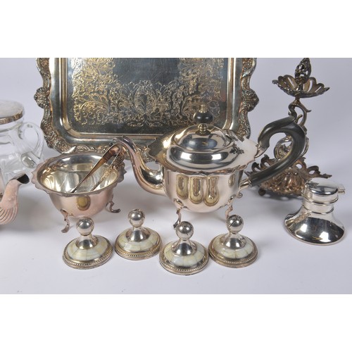 104 - A Silver Plated Tea Tray, a Silver Plated Italian stand with Cupid, Coffee Pots, Place settings, etc... 