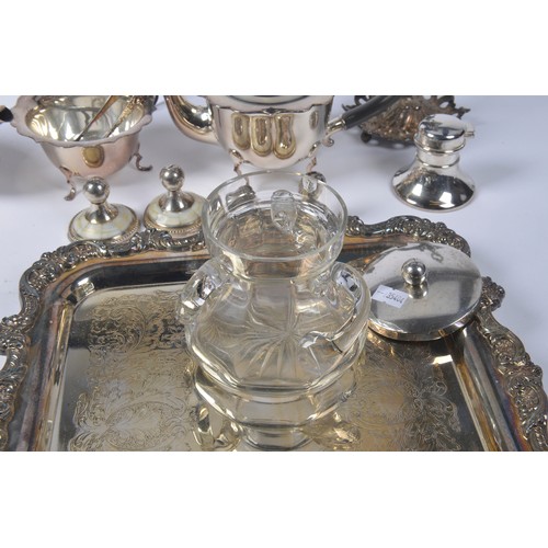 104 - A Silver Plated Tea Tray, a Silver Plated Italian stand with Cupid, Coffee Pots, Place settings, etc... 