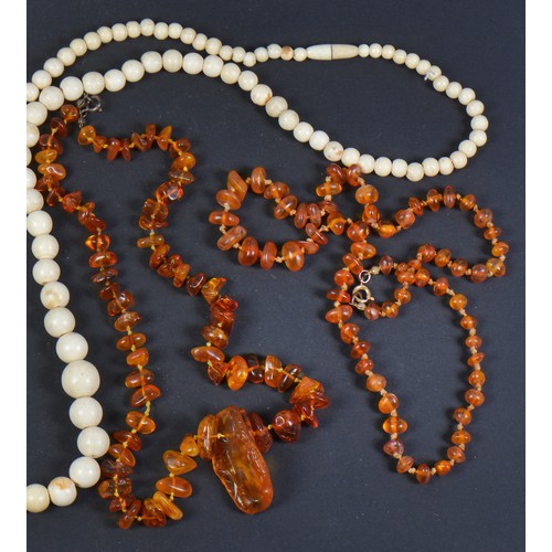 183 - A Collection of Three 'Amber' Necklaces, One Coral Necklace & one Bone Necklace.,