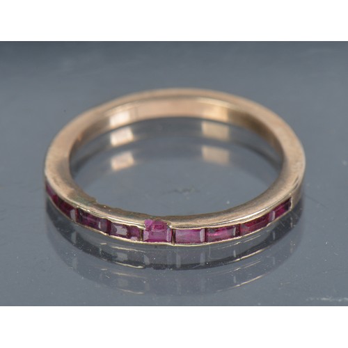 197 - A Ladies Ruby Dress Ring set with a Narrow Band of Ruby's. Size: R.