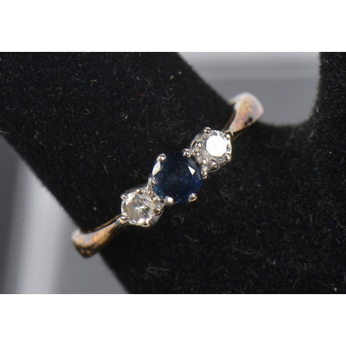 220 - An 18ct Gold Three Stone Sapphire & Diamond Ring. Size: M. Weighing: 2.9 grams.