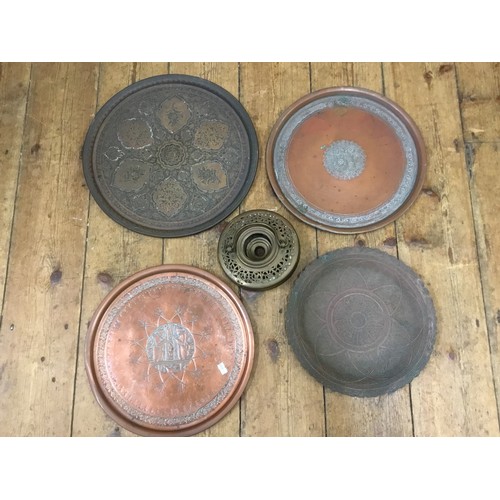 479 - A Collection of Indian & Iranian Copper engraved Tea Trays & Wall Plaques.