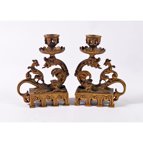 482 - A Pair of French Classical Revival Cast Candlesticks with Stylised Dragons resting on square bases.