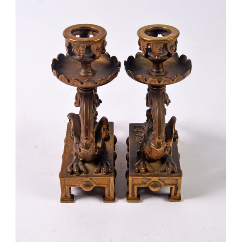 482 - A Pair of French Classical Revival Cast Candlesticks with Stylised Dragons resting on square bases.