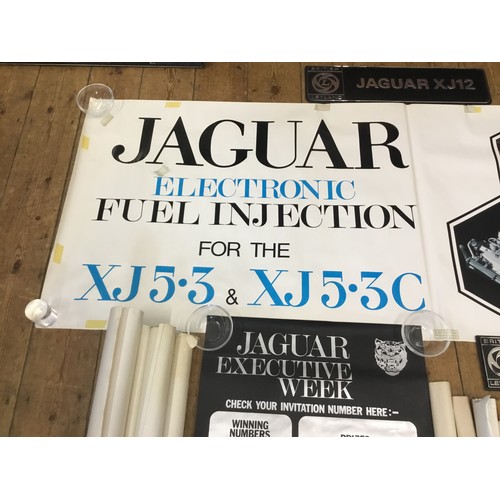 542 - A Collection of Jaguar Dealership/Factory Posters along with Three Showroom Plastic Number Plates de... 