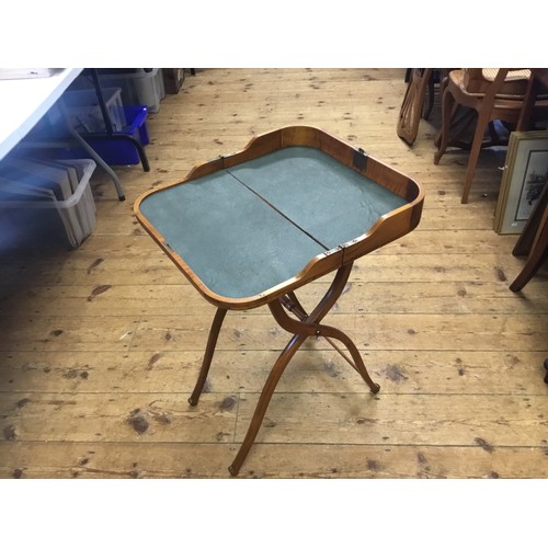 572 - A Late 19th Century American design Curly Maple Folding Coaching Table resting on an X Shaped Base w... 