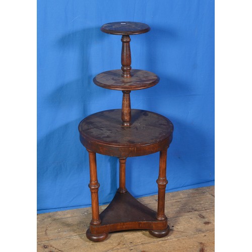 597 - A Continental Three Tiered Waiter resting on a triangular base. Measuring: 103cms high.