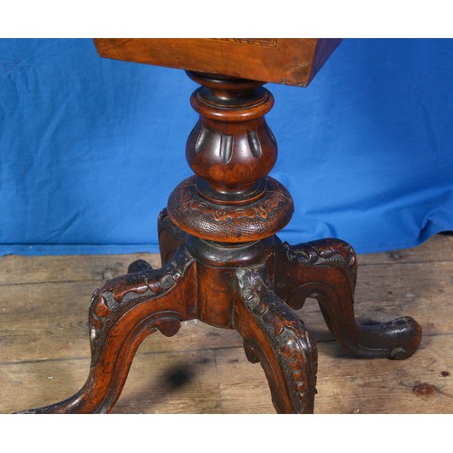 598 - A Victorian Walnut veneered Chess Top Needlework Table resting on a carved Tripod Fluted Base. Measu... 