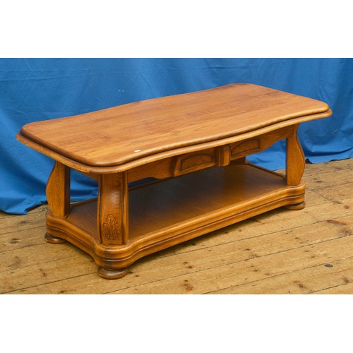 615 - A Continental Oak Coffee Table resting on shaped supports. Measuring: 127cms long x 65cms across x 5... 